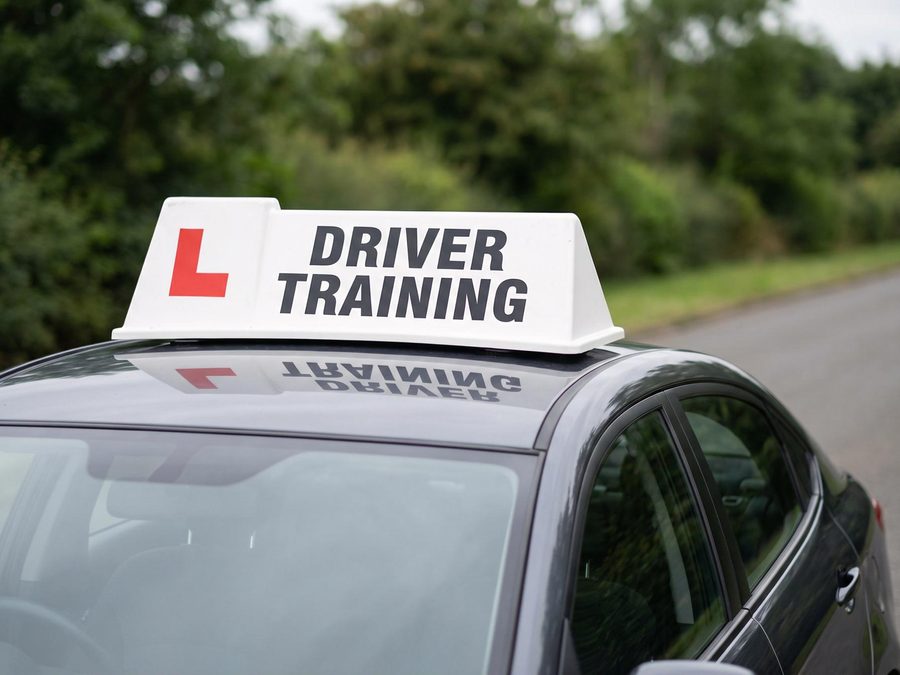 Learner car with a driving school roof sign